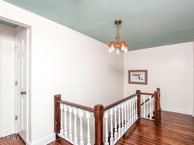 26354 Pewter Ln, Abingdon, VA 24211 - stairway with wood finished floors, a chandelier, baseboards, and a textured ceiling