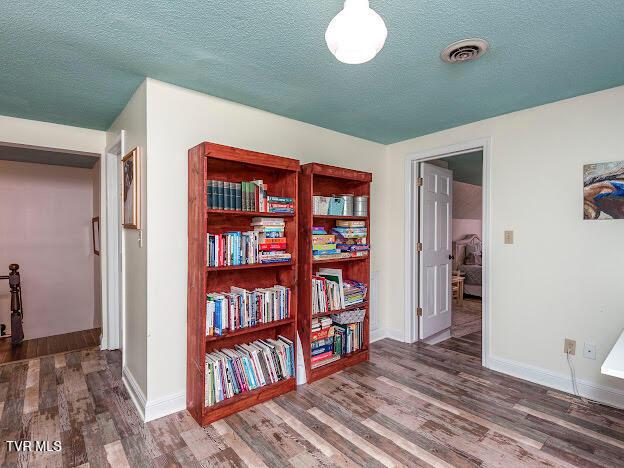 26354 Pewter Ln, Abingdon, VA 24211 - corridor with wood finished floors, a textured ceiling, and baseboards