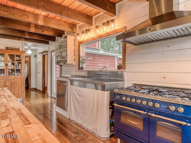 26354 Pewter Ln, Abingdon, VA 24211 - kitchen with wall chimney exhaust hood, range with two ovens, wood counters, dishwasher, and wood finished floors