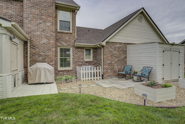 719 W Valley Dr, Kingsport, TN 37664 - back of house featuring a shingled roof, a patio, brick siding, and a lawn