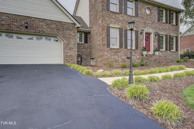 719 W Valley Dr, Kingsport, TN 37664 - view of front of property featuring driveway, brick siding, and an attached garage