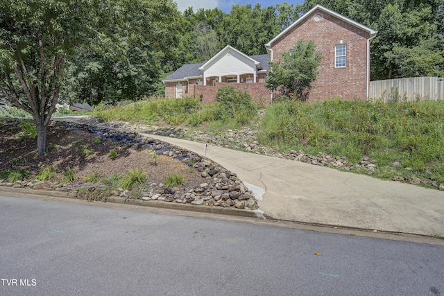 ranch-style house featuring brick siding
