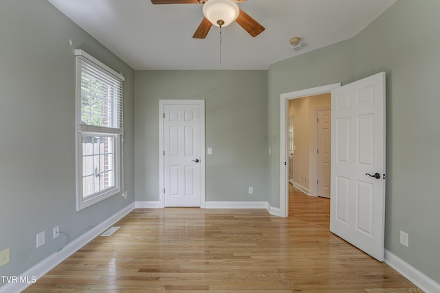 unfurnished bedroom with light wood-type flooring and a ceiling fan