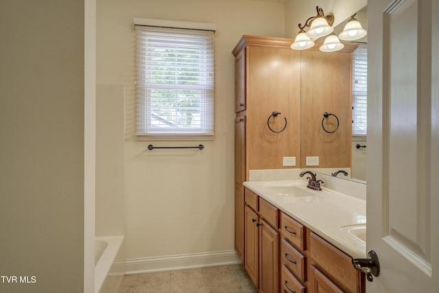 full bath featuring double vanity, tile patterned flooring, and a chandelier