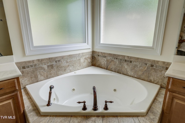 bathroom with vanity and a whirlpool tub