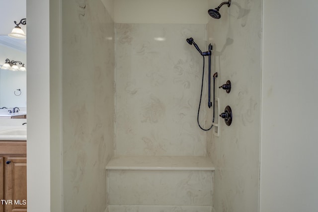 full bathroom featuring a marble finish shower and vanity