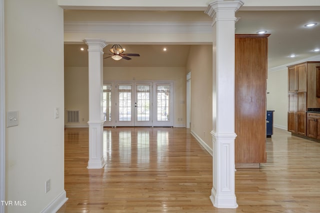 empty room featuring a ceiling fan, ornate columns, light wood-style floors, recessed lighting, and ornamental molding