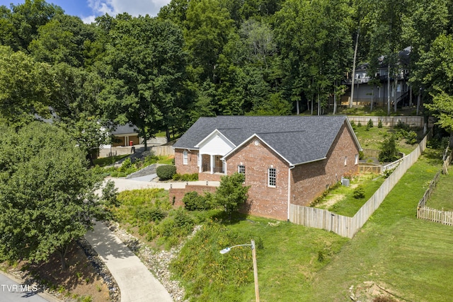 view of front of property with brick siding and roof with shingles