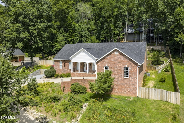 view of front facade with brick siding and roof with shingles
