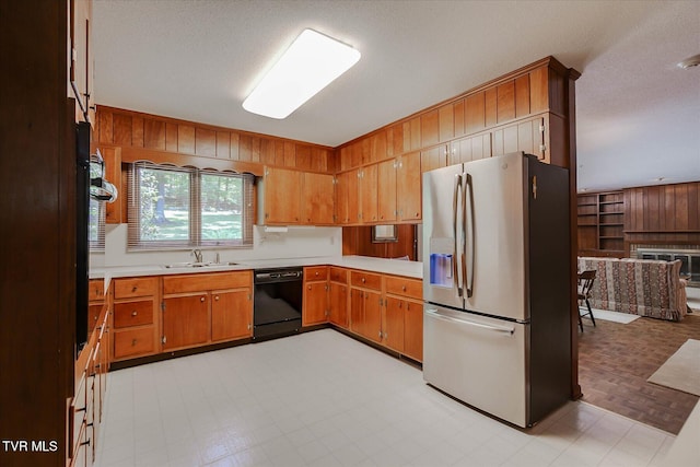 4401 Beechcliff Dr, Kingsport, TN 37664 - kitchen featuring stainless steel refrigerator with ice dispenser, black dishwasher, wooden walls, light countertops, and a textured ceiling