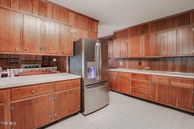 4401 Beechcliff Dr, Kingsport, TN 37664 - kitchen featuring stainless steel fridge, light countertops, brown cabinets, and a textured ceiling