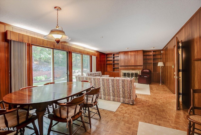4401 Beechcliff Dr, Kingsport, TN 37664 - dining space with wooden walls, built in shelves, a fireplace, and a textured ceiling
