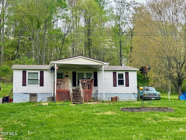 view of front of house with covered porch, a front lawn, and stairway