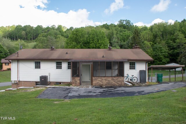 7324 White Pine Cir, Bristol, VA 24202 - back of house with a lawn, a chimney, a view of trees, and cooling unit