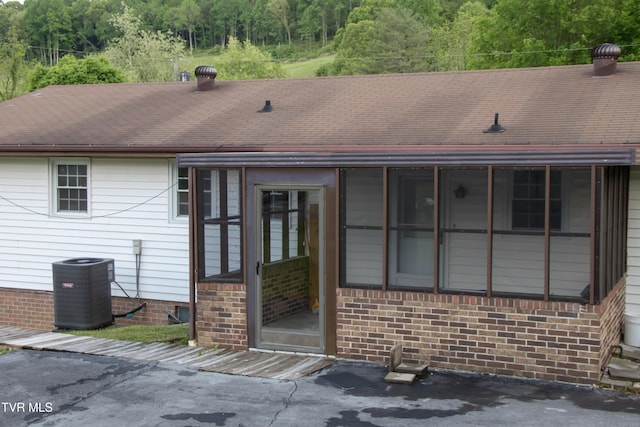 7324 White Pine Cir, Bristol, VA 24202 - back of property with cooling unit, a forest view, and a shingled roof