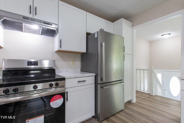 7324 White Pine Cir, Bristol, VA 24202 - kitchen featuring stainless steel appliances, under cabinet range hood, light countertops, light wood finished floors, and white cabinets