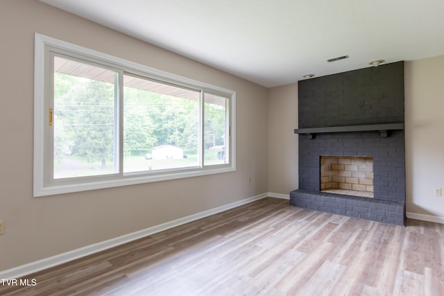 7324 White Pine Cir, Bristol, VA 24202 - unfurnished living room with wood finished floors, baseboards, and a fireplace