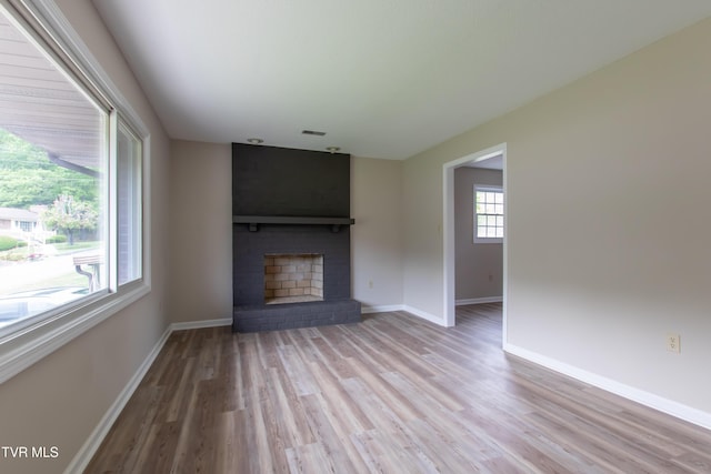 7324 White Pine Cir, Bristol, VA 24202 - unfurnished living room featuring wood finished floors, a fireplace, and baseboards