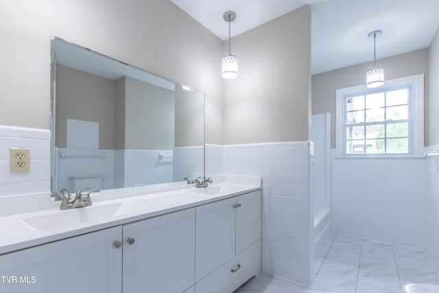7324 White Pine Cir, Bristol, VA 24202 - bathroom featuring tile walls, marble finish flooring, double vanity, wainscoting, and a tub to relax in