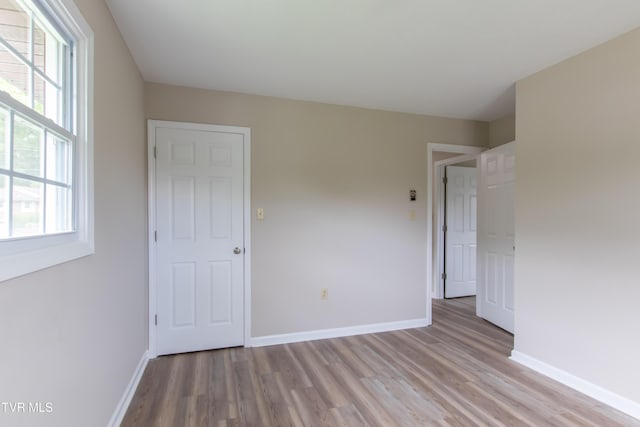 7324 White Pine Cir, Bristol, VA 24202 - unfurnished bedroom with light wood-type flooring, baseboards, and multiple windows