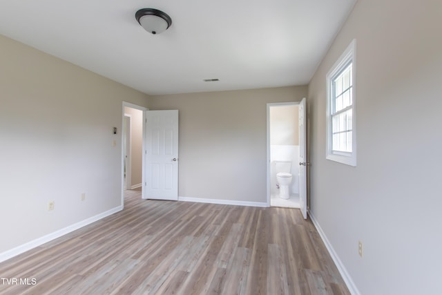 7324 White Pine Cir, Bristol, VA 24202 - unfurnished bedroom featuring light wood-type flooring, baseboards, and ensuite bath