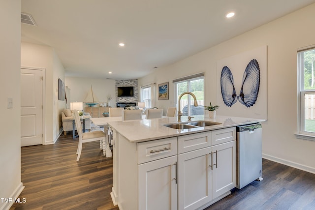 2340 Hamshire St, Johnson City, TN 37601 - kitchen featuring a sink, dishwasher, a fireplace, a kitchen island with sink, and white cabinetry
