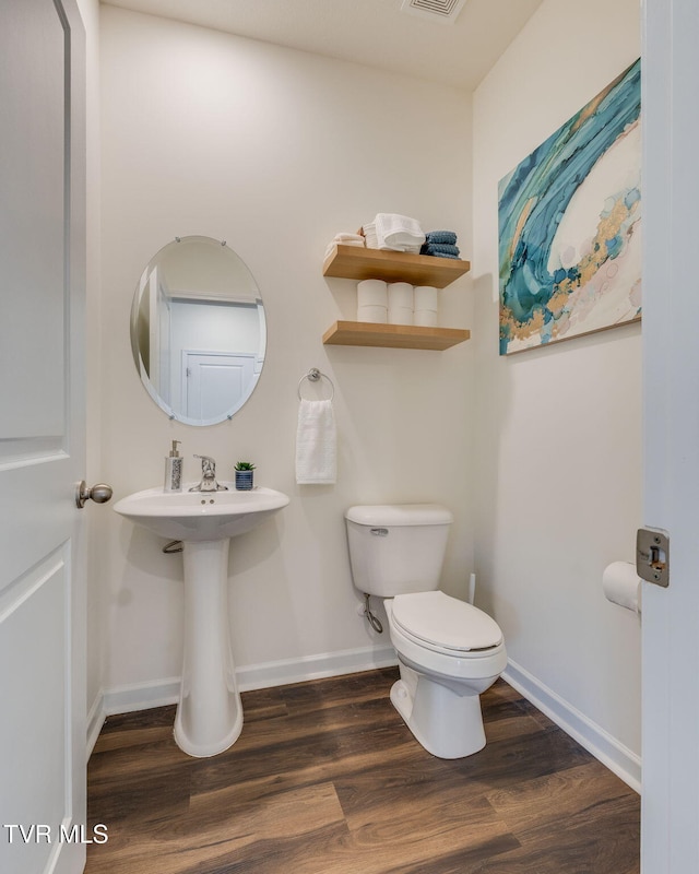 2340 Hamshire St, Johnson City, TN 37601 - bathroom featuring toilet, wood finished floors, and baseboards