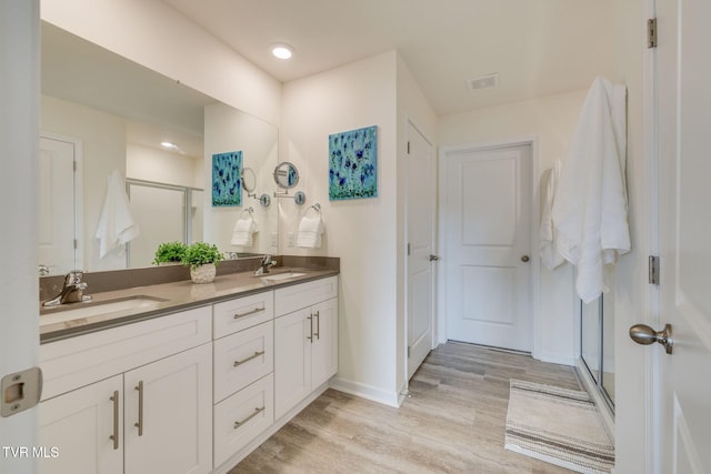 2340 Hamshire St, Johnson City, TN 37601 - full bath with double vanity, wood finished floors, a stall shower, baseboards, and recessed lighting