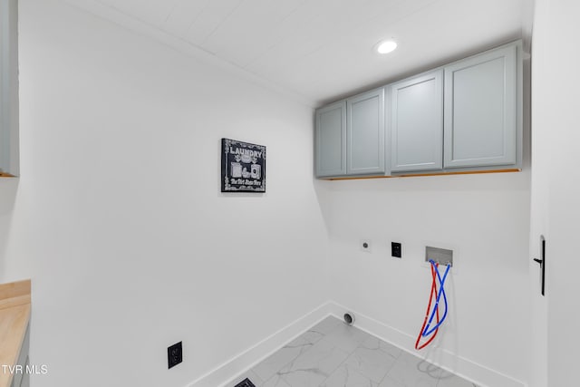 washroom featuring hookup for an electric dryer, washer hookup, cabinet space, baseboards, and marble finish flooring