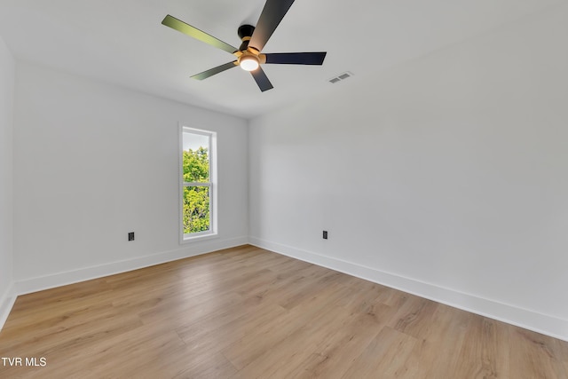 unfurnished room featuring baseboards, light wood-style floors, and ceiling fan