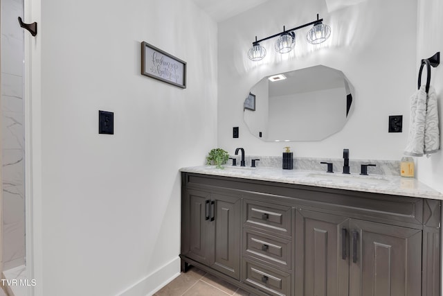 bathroom featuring double vanity, baseboards, and tile patterned flooring
