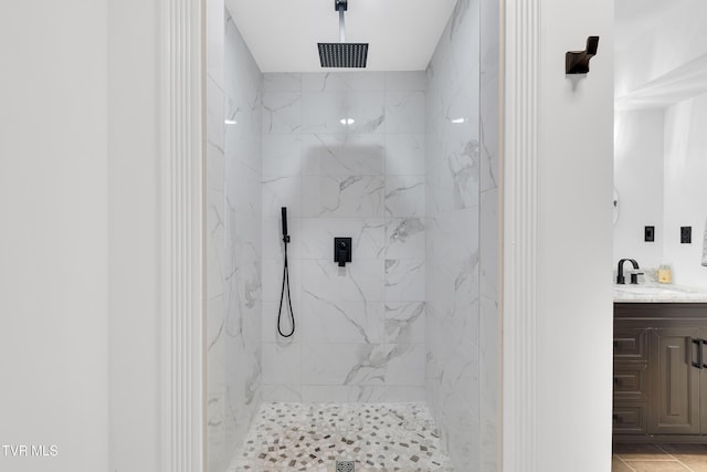 full bathroom featuring vanity and a marble finish shower