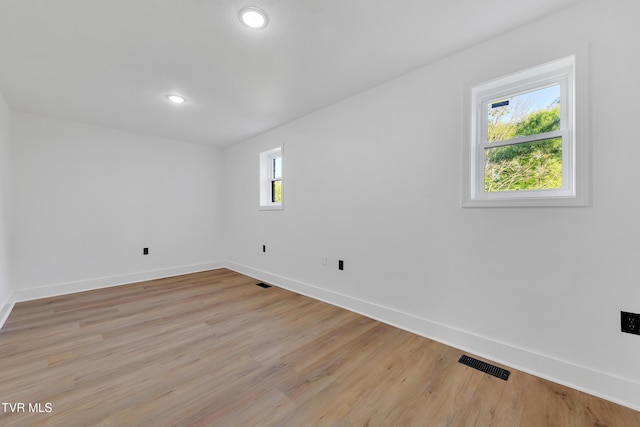 unfurnished room featuring baseboards, light wood finished floors, and recessed lighting