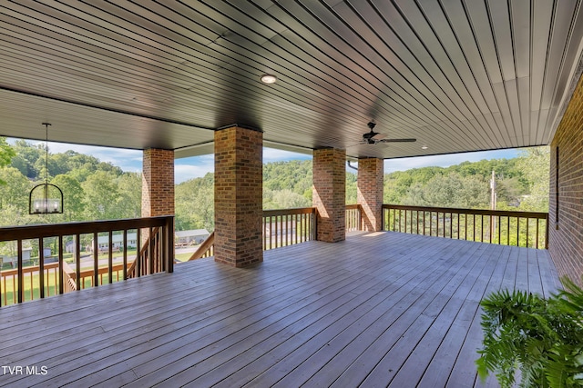 wooden terrace featuring a ceiling fan