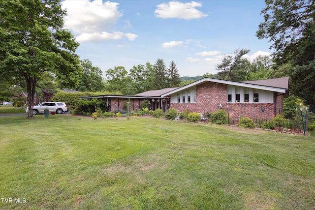 view of front of home featuring brick siding and a front yard