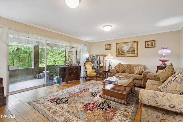 living room with hardwood / wood-style flooring and ornamental molding