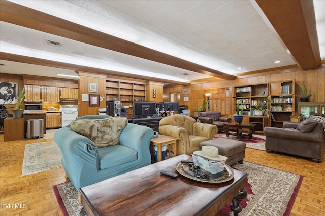 living area with wooden walls and built in shelves
