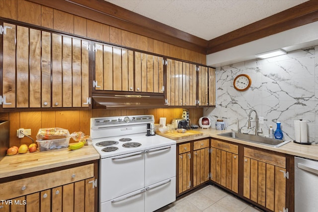 kitchen with double oven range, a sink, under cabinet range hood, stainless steel dishwasher, and brown cabinetry