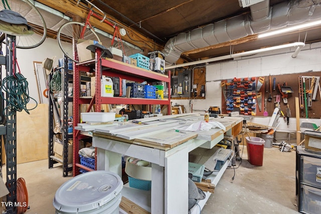misc room featuring unfinished concrete flooring and a workshop area