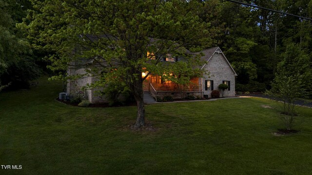 588 Spring Valley Rd, Bristol, VA 24201 - view of property exterior featuring a lawn, a wooded view, and central air condition unit
