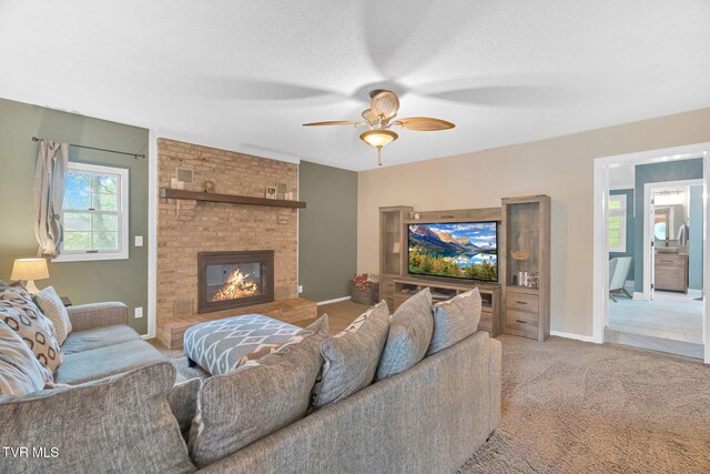 588 Spring Valley Rd, Bristol, VA 24201 - carpeted living area featuring a ceiling fan, a fireplace, a textured ceiling, and baseboards