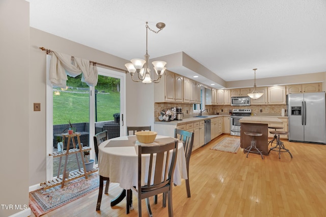 588 Spring Valley Rd, Bristol, VA 24201 - dining space featuring light wood-type flooring, a chandelier, and a textured ceiling