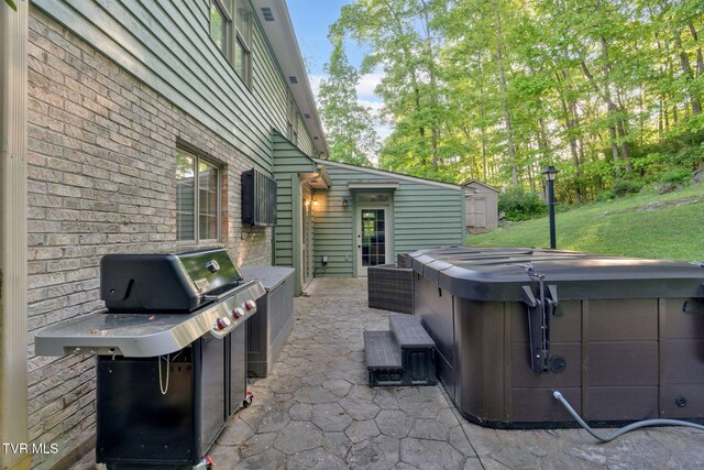 588 Spring Valley Rd, Bristol, VA 24201 - view of patio / terrace with a hot tub, a storage unit, an outbuilding, and grilling area