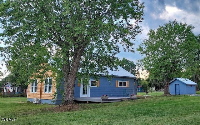 7780 Roy Rogers Dr, Whitesburg, TN 37891 - back of house featuring a lawn, a shed, an outdoor structure, and a wooden deck