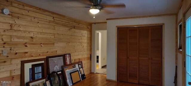 7780 Roy Rogers Dr, Whitesburg, TN 37891 - unfurnished bedroom with wooden walls, wood finished floors, a closet, and ceiling fan