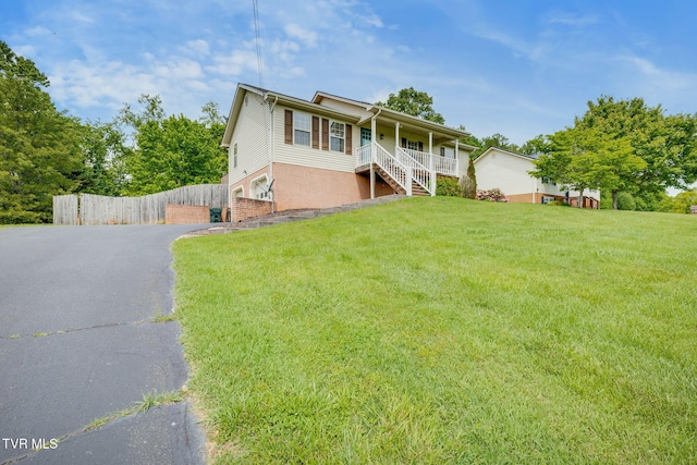 view of front of property featuring a porch, driveway, stairs, and brick siding