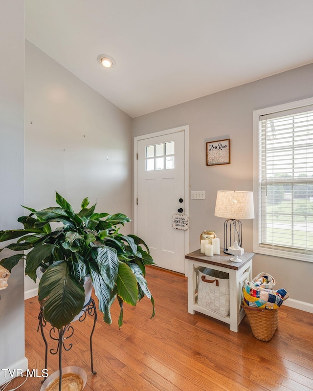 entrance foyer featuring light wood-style flooring and baseboards