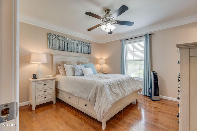 bedroom featuring crown molding, light wood finished floors, baseboards, and a ceiling fan