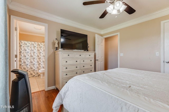 bedroom featuring hardwood / wood-style floors, ornamental molding, ensuite bathroom, and ceiling fan