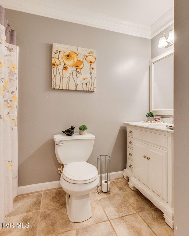 bathroom with ornamental molding, toilet, vanity, tile patterned floors, and baseboards